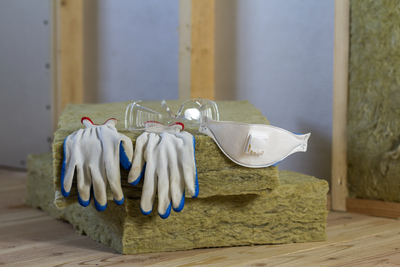 Gants posés sur des panneaux d'isolant thermique.