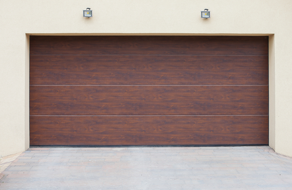 Isolation porte de garage sectionnelle en bois de couleur marrron.